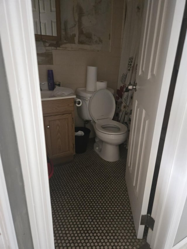 1206 August Rd, North Babylon, NY 11703 - bathroom featuring tile walls, vanity, and tile patterned flooring