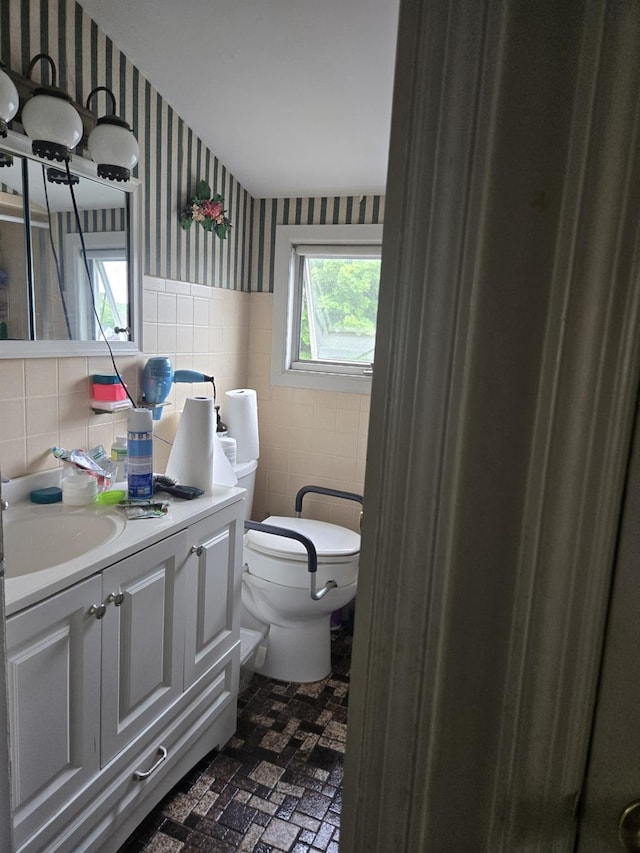1206 August Rd, North Babylon, NY 11703 - bathroom featuring wallpapered walls, tile walls, vanity, brick patterned flooring, and a wainscoted wall