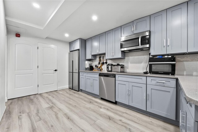 62 Buchanan Pl, Bronx, NY 10453 - kitchen featuring black appliances, gray cabinetry, recessed lighting, and light wood-type flooring