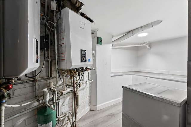 62 Buchanan Pl, Bronx, NY 10453 - utility room featuring tankless water heater and water heater