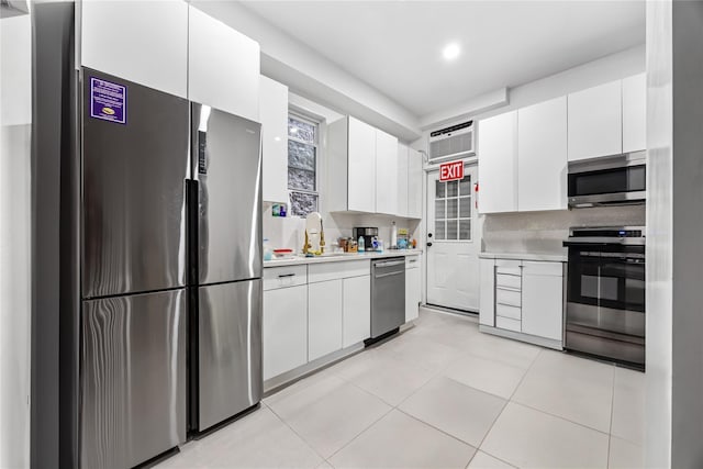 62 Buchanan Pl, Bronx, NY 10453 - kitchen featuring appliances with stainless steel finishes, light countertops, white cabinets, and recessed lighting