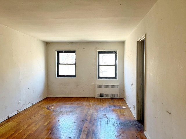 83-83 118th St Unit 6L, Kew Gardens, NY 11415 - empty room featuring radiator heating unit and hardwood / wood-style floors