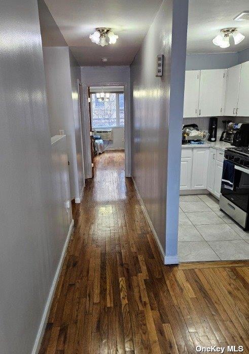 2298 Loring Pl N, Bronx, NY 10468 - corridor featuring light wood-style flooring and baseboards