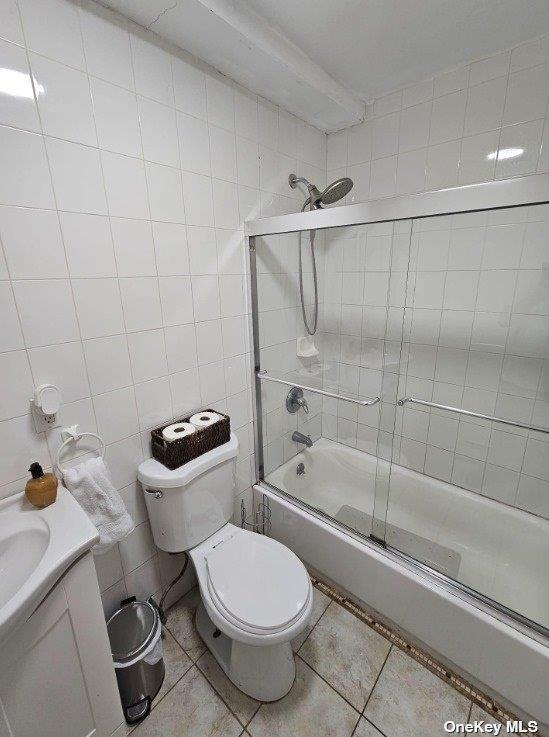 2298 Loring Pl N, Bronx, NY 10468 - bathroom with enclosed tub / shower combo, vanity, tile patterned flooring, and tile walls