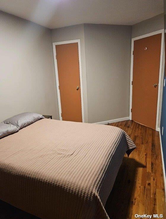 2298 Loring Pl N, Bronx, NY 10468 - bedroom featuring wood finished floors and baseboards