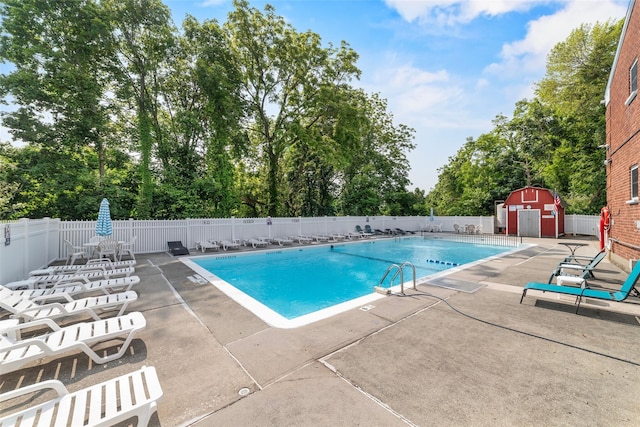 1879 Crompond Rd Unit E16, Peekskill, NY 10566 - community pool featuring a patio, a storage unit, and view of scattered trees
