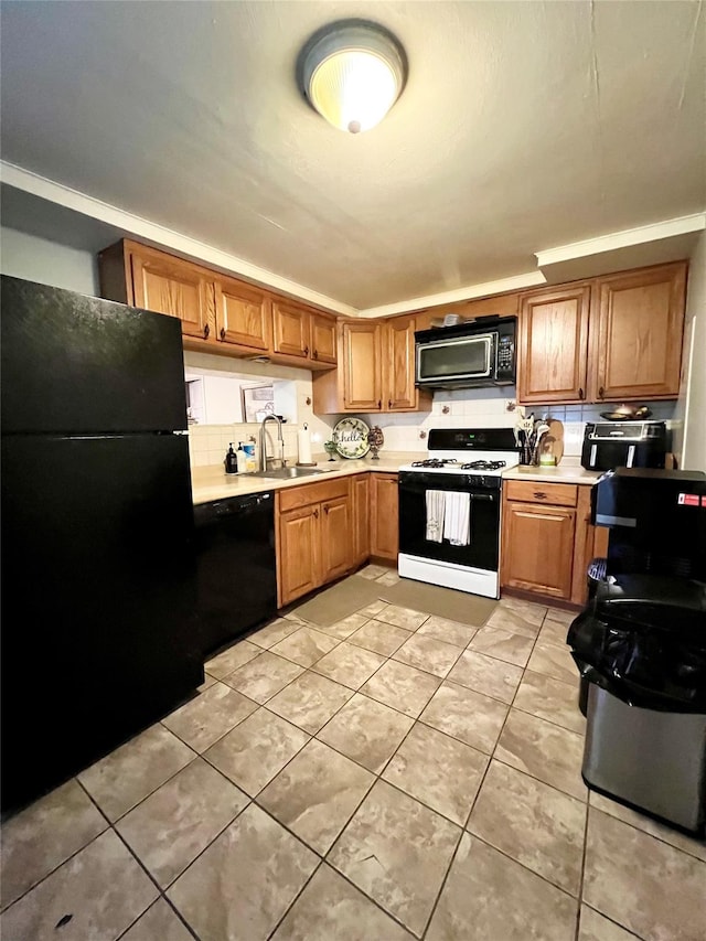 33 Roosevelt Pl, Stony Point, NY 10980 - kitchen with black appliances, light countertops, light tile patterned floors, decorative backsplash, and brown cabinets