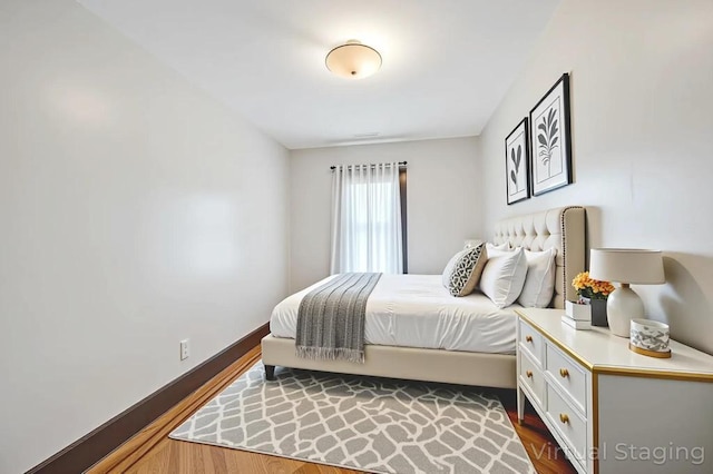 11467 202nd St, Saint Albans, NY 11412 - bedroom featuring dark wood-style flooring and baseboards