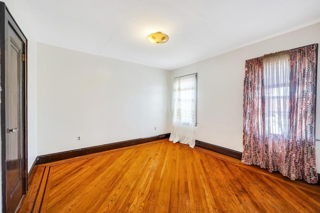 11467 202nd St, Saint Albans, NY 11412 - unfurnished room featuring wood finished floors and baseboards