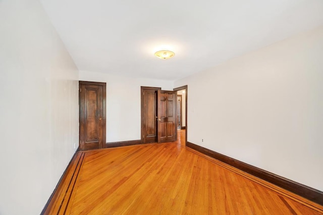 11467 202nd St, Saint Albans, NY 11412 - unfurnished bedroom with baseboards and light wood-style flooring