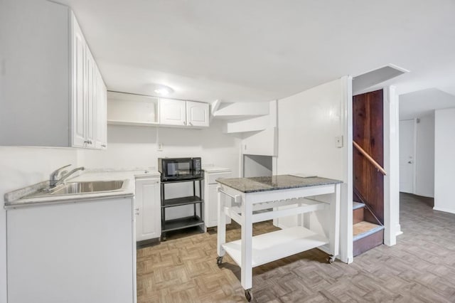 11467 202nd St, Saint Albans, NY 11412 - kitchen with open shelves, white cabinets, and black microwave