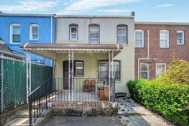 11467 202nd St, Saint Albans, NY 11412 - view of front facade with stucco siding and covered porch