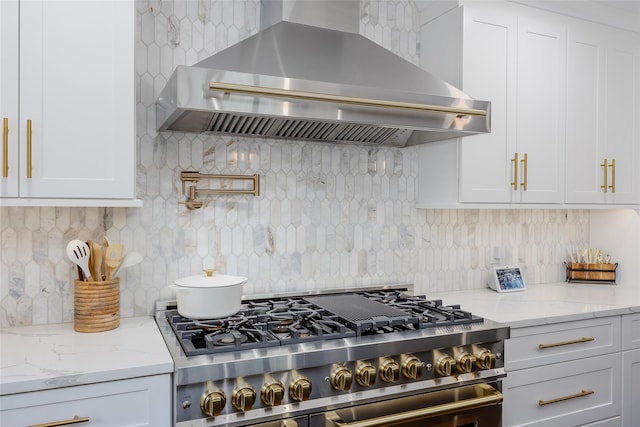 7 Long View Dr, Wading River, NY 11792 - kitchen featuring wall chimney range hood, high end stove, backsplash, and white cabinetry