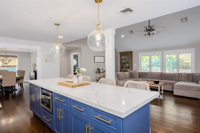 7 Long View Dr, Wading River, NY 11792 - kitchen with blue cabinets, open floor plan, dark wood-style floors, vaulted ceiling, and recessed lighting