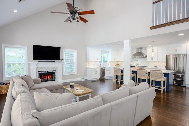 7 Long View Dr, Wading River, NY 11792 - living room featuring ceiling fan, high vaulted ceiling, dark wood finished floors, a lit fireplace, and recessed lighting