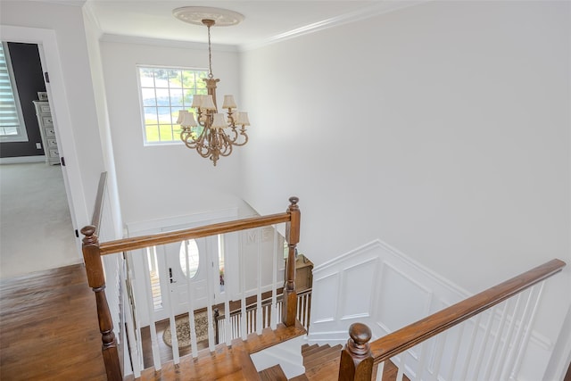 7 Long View Dr, Wading River, NY 11792 - stairway with a chandelier, crown molding, wood finished floors, a decorative wall, and a wainscoted wall