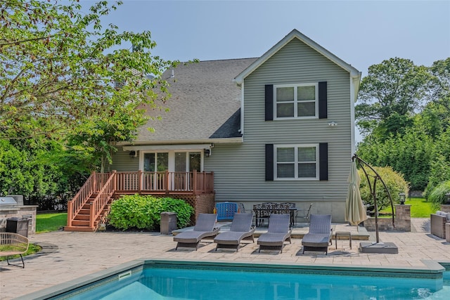 7 Long View Dr, Wading River, NY 11792 - rear view of property with a wooden deck, stairs, an outdoor pool, a patio area, and roof with shingles