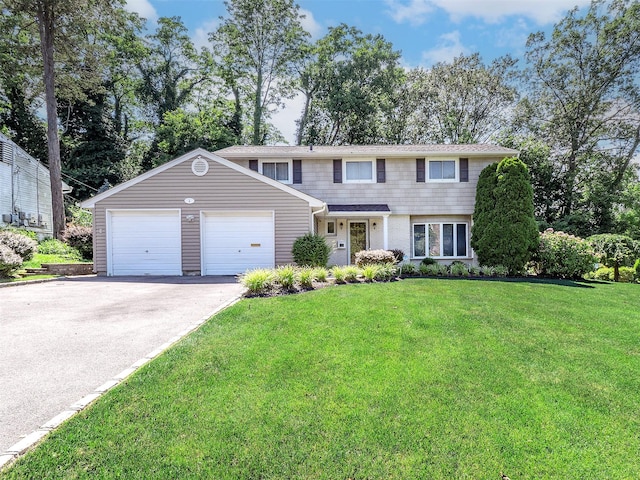 1 Barry Dr, Glen Cove, NY 11542 - view of front of home with a front lawn, an attached garage, and driveway