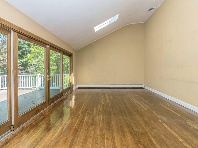 1 Barry Dr, Glen Cove, NY 11542 - unfurnished room featuring lofted ceiling, a skylight, hardwood / wood-style flooring, and a baseboard heating unit