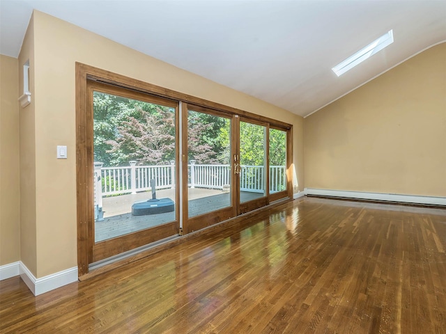 1 Barry Dr, Glen Cove, NY 11542 - spare room with a baseboard radiator, wood finished floors, and vaulted ceiling