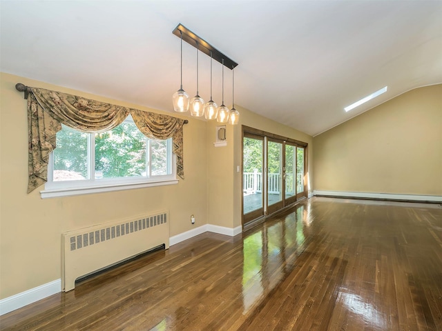 1 Barry Dr, Glen Cove, NY 11542 - unfurnished room featuring radiator, a baseboard radiator, vaulted ceiling, and hardwood / wood-style flooring
