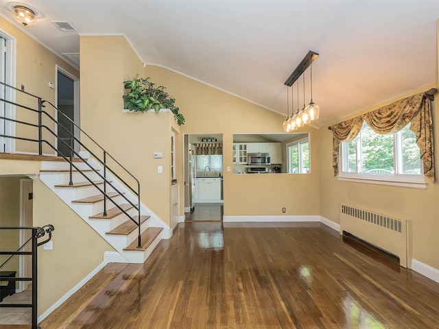 1 Barry Dr, Glen Cove, NY 11542 - foyer with radiator, hardwood / wood-style flooring, ornamental molding, stairs, and lofted ceiling