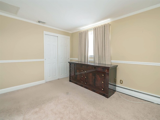 1 Barry Dr, Glen Cove, NY 11542 - unfurnished bedroom with crown molding, a closet, carpet floors, and baseboard heating