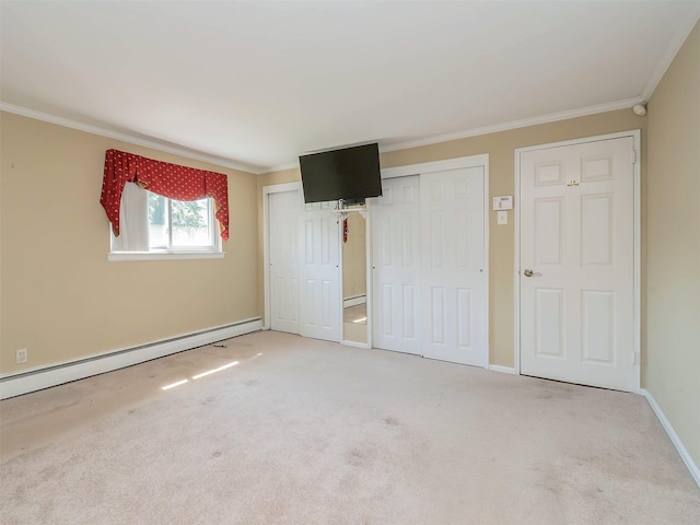 1 Barry Dr, Glen Cove, NY 11542 - unfurnished bedroom featuring ornamental molding, a baseboard heating unit, carpet, and a closet
