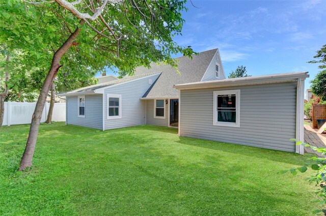 17 Windmill Ln, Levittown, NY 11756 - rear view of property featuring roof with shingles