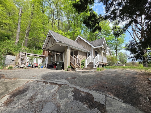 248 Pound Ridge Rd, Bedford, NY 10506 - view of front facade with stairway, a porch, a shingled roof, and driveway