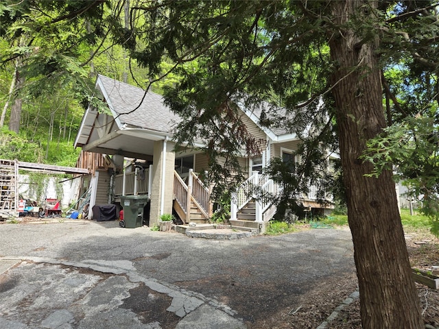 248 Pound Ridge Rd, Bedford, NY 10506 - view of front of home featuring a shingled roof, a porch, and stairs