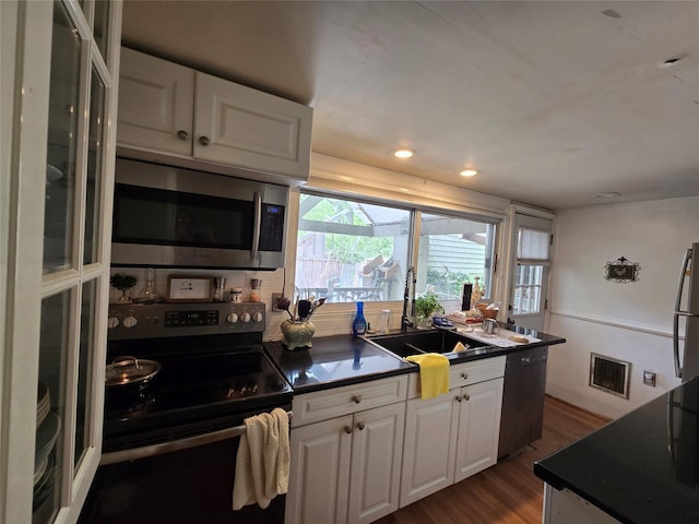 248 Pound Ridge Rd, Bedford, NY 10506 - kitchen featuring appliances with stainless steel finishes, dark countertops, white cabinetry, dark wood-type flooring, and recessed lighting