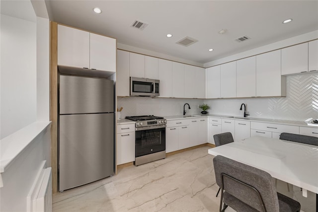 17 Union Rd Unit 108, Spring Valley, NY 10977 - kitchen with stainless steel appliances, light marble finish floors, decorative backsplash, light countertops, and recessed lighting