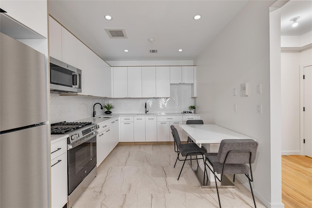 17 Union Rd Unit 108, Spring Valley, NY 10977 - kitchen with appliances with stainless steel finishes, light countertops, decorative backsplash, recessed lighting, and modern cabinets