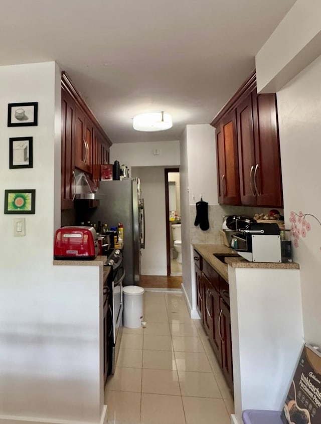 66-36 Yellowstone Blvd Unit 4F, Forest Hills, NY 11375 - kitchen featuring light tile patterned floors, light countertops, and under cabinet range hood