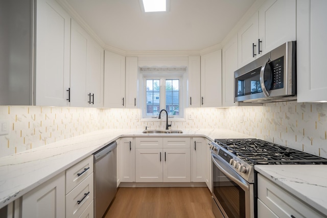 67-23 182nd St, Fresh Meadows, NY 11365 - kitchen with appliances with stainless steel finishes, backsplash, and white cabinets