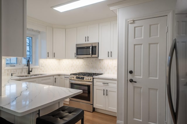 67-23 182nd St, Fresh Meadows, NY 11365 - kitchen with appliances with stainless steel finishes, decorative backsplash, and light stone counters