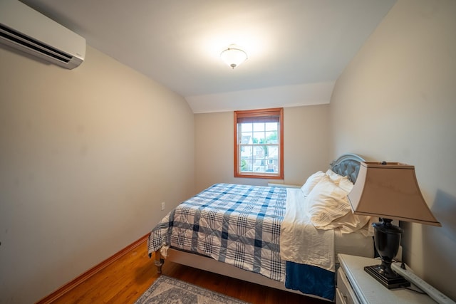 67-23 182nd St, Fresh Meadows, NY 11365 - bedroom featuring a wall mounted air conditioner, wood finished floors, and vaulted ceiling