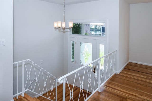 108 Kensington Oval, New Rochelle, NY 10805 - stairway with wood finished floors and a chandelier