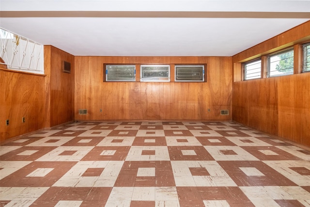 108 Kensington Oval, New Rochelle, NY 10805 - unfurnished room featuring wood walls, tile patterned floors, and a wall mounted AC