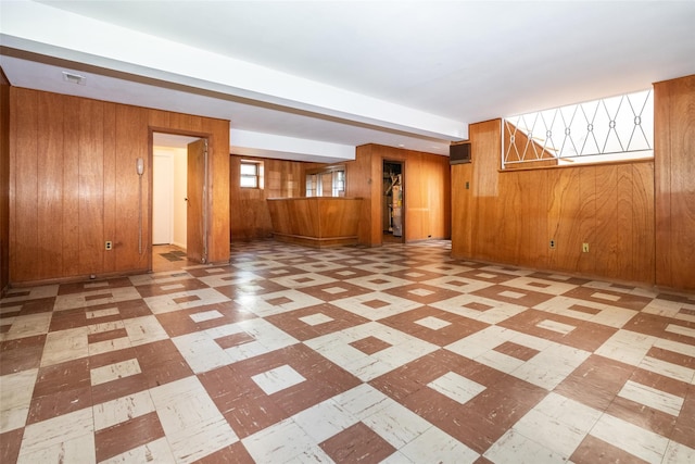 108 Kensington Oval, New Rochelle, NY 10805 - unfurnished living room featuring wood walls and tile patterned floors