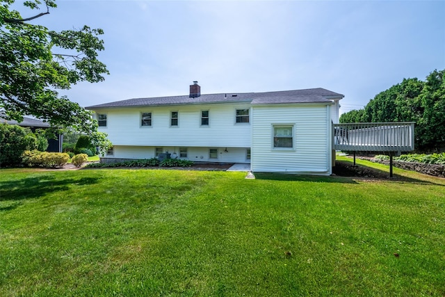 108 Kensington Oval, New Rochelle, NY 10805 - rear view of house featuring a wooden deck, a chimney, and a yard