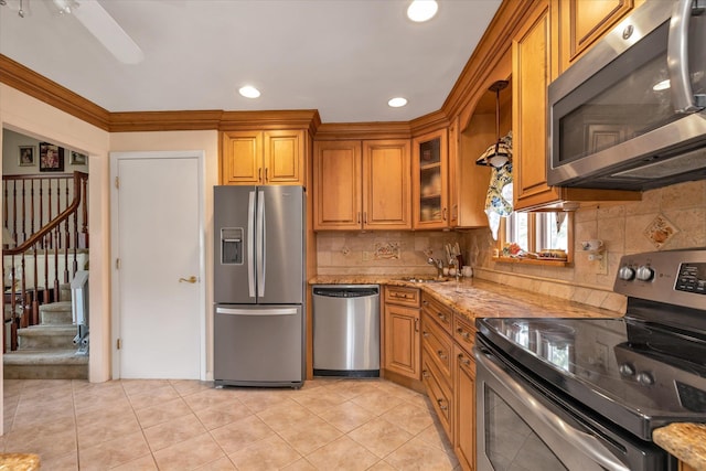 1182 Adrienne Ln, Seaford, NY 11783 - kitchen with stainless steel appliances, brown cabinetry, light tile patterned floors, backsplash, and recessed lighting