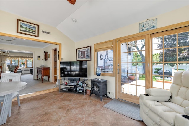 1182 Adrienne Ln, Seaford, NY 11783 - living area featuring lofted ceiling, a baseboard radiator, a wood stove, radiator, and light tile patterned flooring