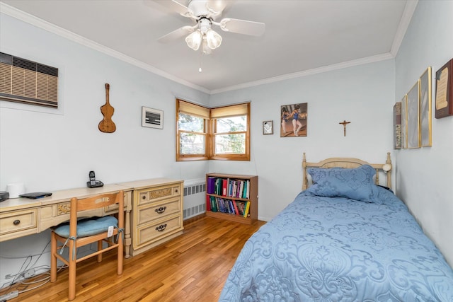 1182 Adrienne Ln, Seaford, NY 11783 - bedroom featuring radiator heating unit, light wood-style flooring, ornamental molding, and an office area
