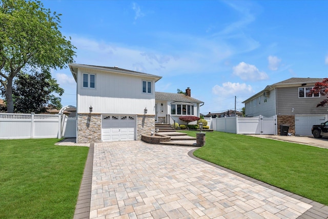 1182 Adrienne Ln, Seaford, NY 11783 - split level home featuring a gate, a garage, decorative driveway, and stone siding