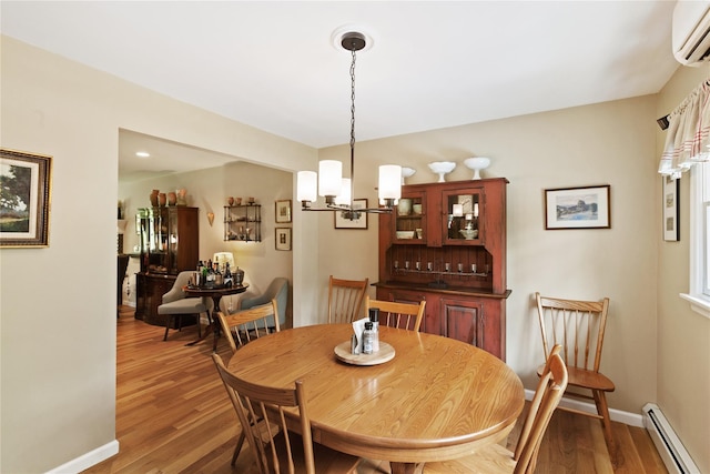 1 Hawthorne Ct, North Salem, NY 10560 - dining area featuring a baseboard heating unit, a wall mounted AC, a chandelier, and wood finished floors