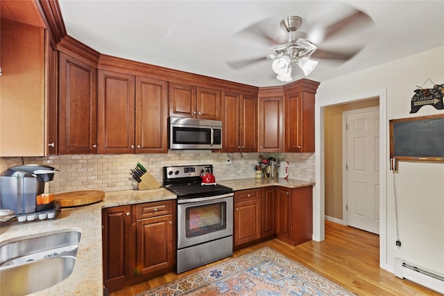 1 Hawthorne Ct, North Salem, NY 10560 - kitchen with appliances with stainless steel finishes, a baseboard radiator, light wood finished floors, backsplash, and ceiling fan