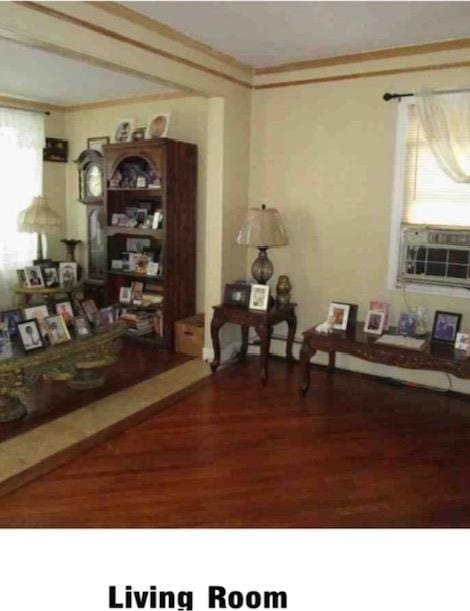 135-15 243rd St, Rosedale, NY 11422 - living area with wood finished floors, crown molding, and cooling unit