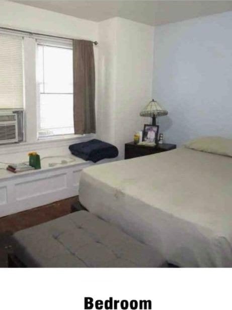 135-15 243rd St, Rosedale, NY 11422 - bedroom featuring cooling unit and dark wood finished floors